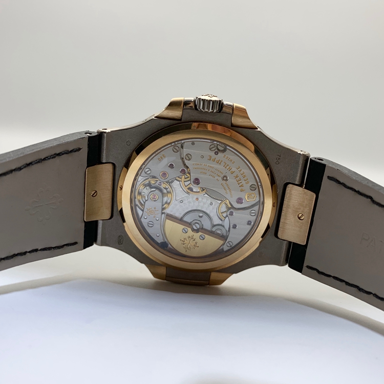 PATEK PHILIPPE 百达翡丽 NAUTILUS 运动系列，5712GR-001。40毫米表径，18K玫瑰金/18K白金表壳，10个18K玫瑰金棒式时标，18K玫瑰金棒式时针分针，白色涂漆18K黄金秒针、指针式日期显示、动力储备显示、月相显示功能，Cal.240 PS IRM C LU自动上弦机械机芯，动力储备48小时。专柜定价：339900元。 全套附件齐全。