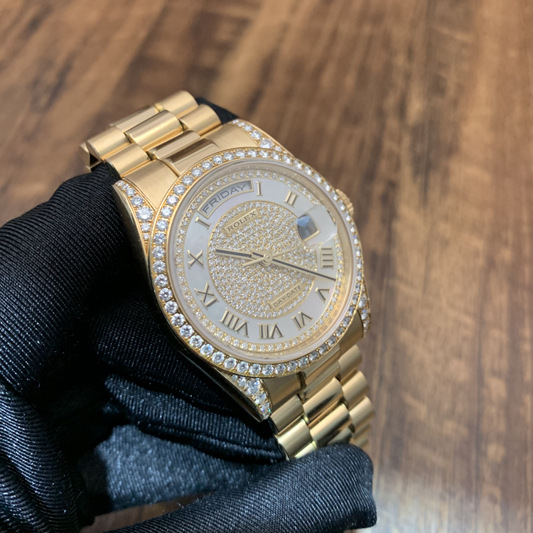 Rolex 劳力士 星期日历型系列，m118388-0030。36毫米表径，18K黄金原钻表壳，珍珠母贝密镶钻石面盘，罗马数字时标，中央时、分及秒针；快调瞬跳星期日历；3点位置为防反光凸透式放大日历窗，12点位置为星期显示，3155自动上弦机械机芯。 全套附件齐全。