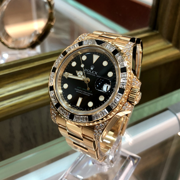 Rolex 劳力士 格林尼治型II系列，116758。40毫米表径，18k黄金镶钻黑色蓝宝石，表圈共镶嵌36颗钻石和黑色蓝宝石12颗，黑色面盘，3点位置日期显示，自产3186自动上弦机械机芯。专柜定价：965200元。 全套附件齐全。