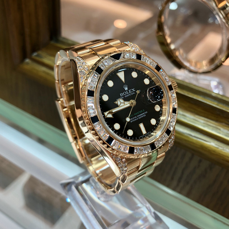 Rolex 劳力士 格林尼治型II系列，116758。40毫米表径，18k黄金镶钻黑色蓝宝石，表圈共镶嵌36颗钻石和黑色蓝宝石12颗，黑色面盘，3点位置日期显示，自产3186自动上弦机械机芯。专柜定价：965200元。 全套附件齐全。