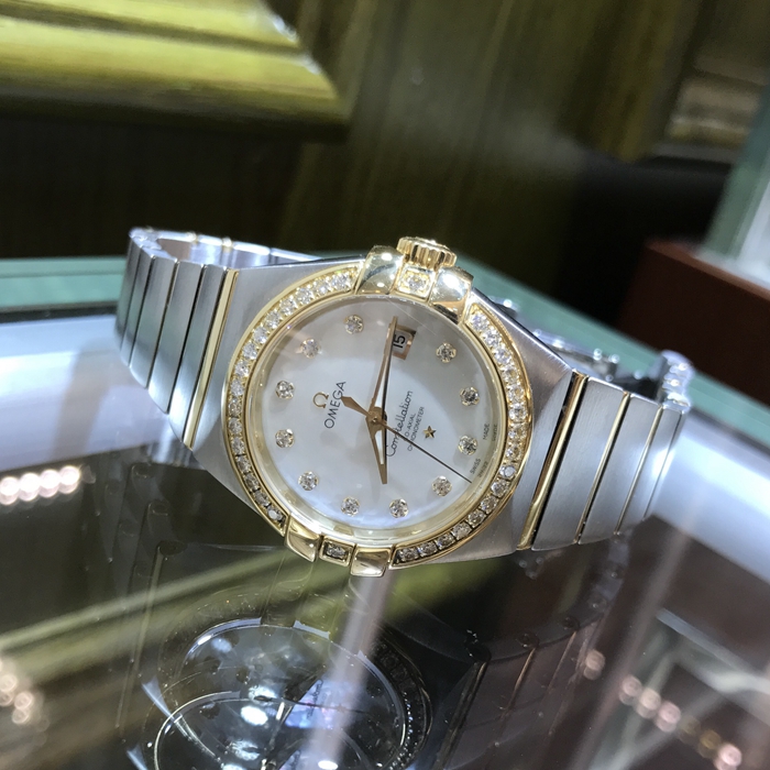 Omega 欧米茄 星座系列，123.25.31.20.55.003。31毫米表径，18K黄金镶钻表壳，珍珠贝母面，镶钻时标，三点位置视窗式日期显示，自动机械机芯，动力储备50小时。 单表无附件。